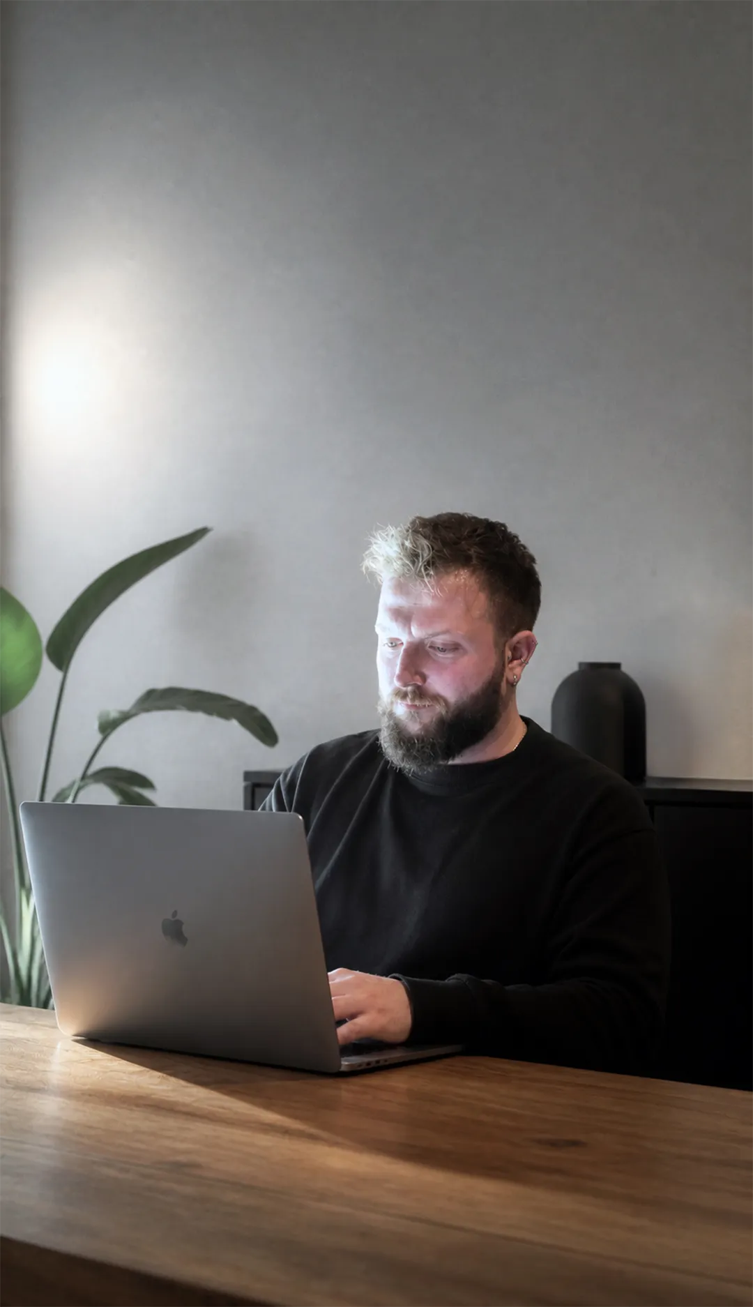 Portrait of Efe Can Akar working on a laptop